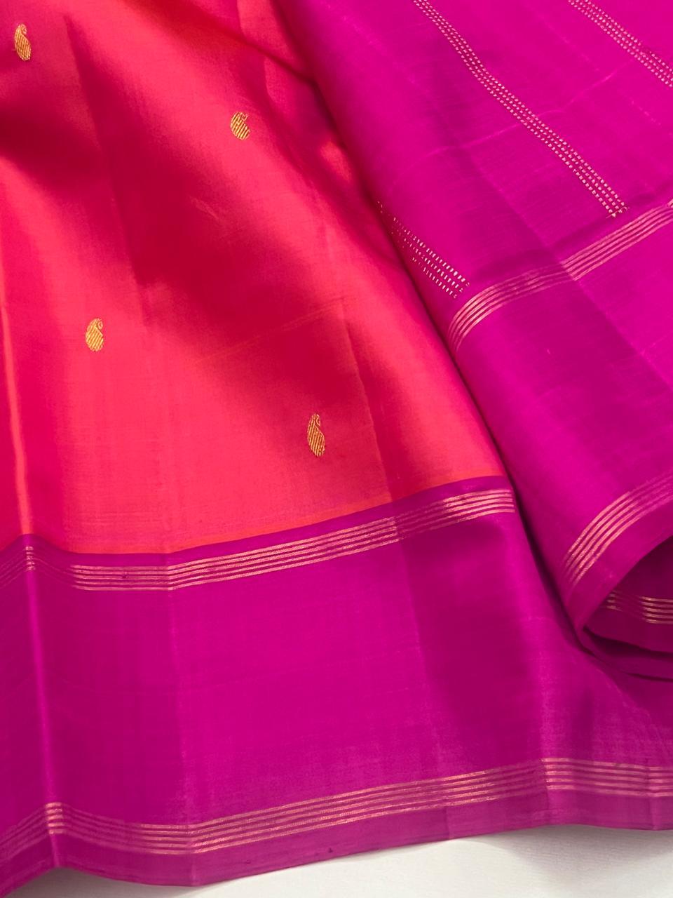 Orange Kanchipuram Silk Saree with a Contrast Pink Zari Border